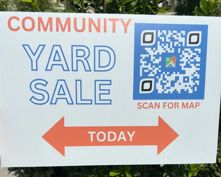 a yard sign with a QR code